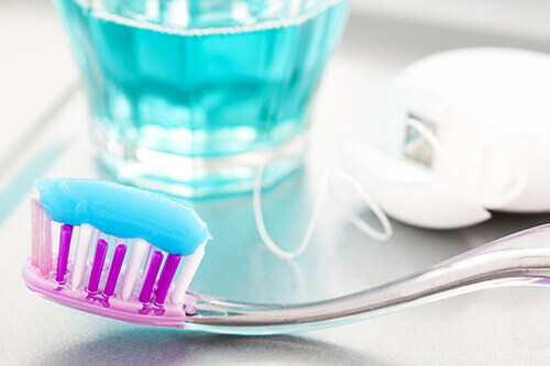 Dental Tools and a Toothbrush With Blue Toothpaste