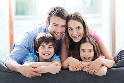 Young family posing on back of couch